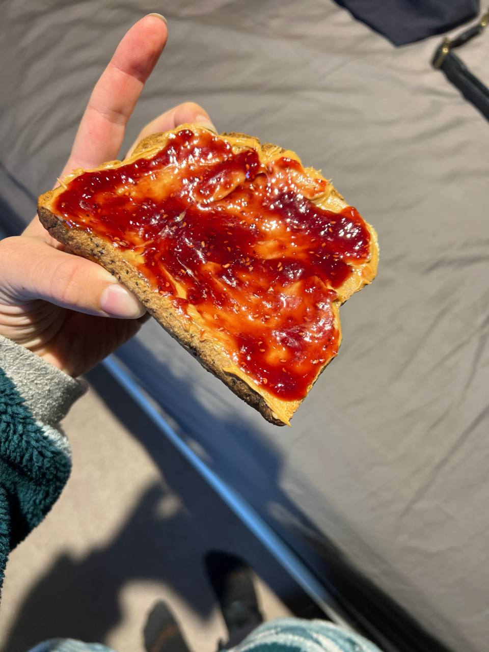 slice of bread with peanut butter and raspberry jam