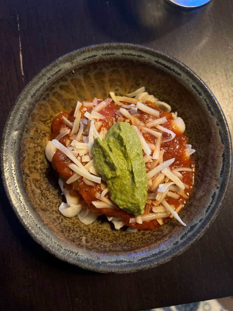 pasta with tomato sauce, broccoli, dairy-free Violife cheese, and a spoon of homemade kale pesto on top