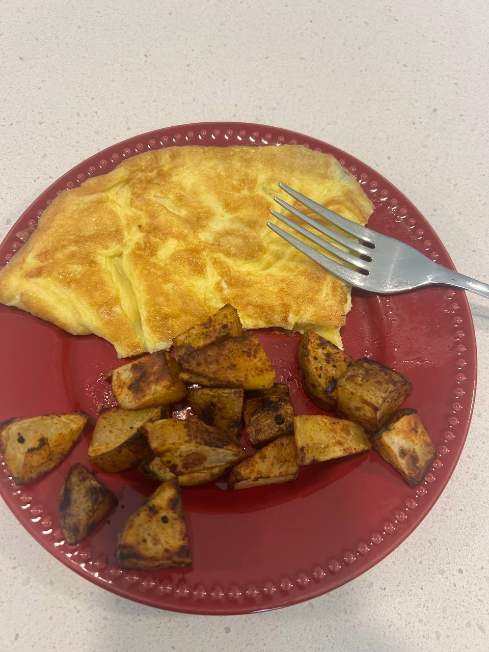 Eggs (folded omelette-style, described as two scrambled eggs), Roasted diced potatoes