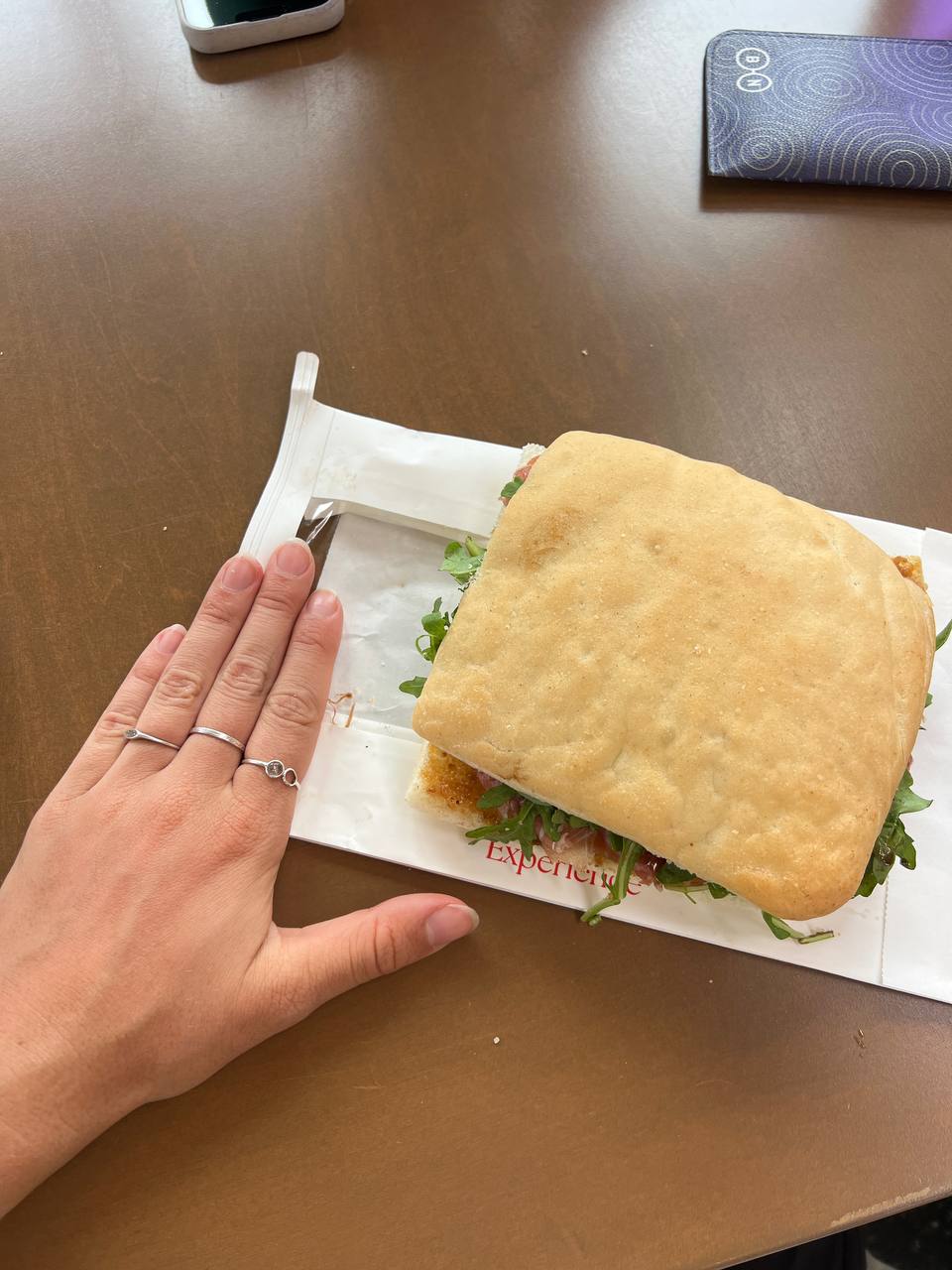 Gluten-free focaccia bread (top and bottom slices), Prosciutto, Arugula (rocket), Pine nuts, Fig jam, Balsamic reduction